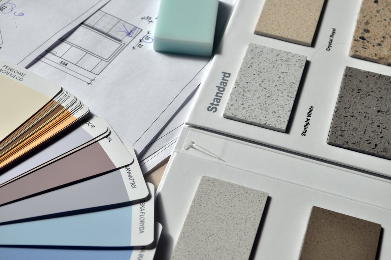 Strona główna Color palette and material samples for interior renovation projects on a blueprint.